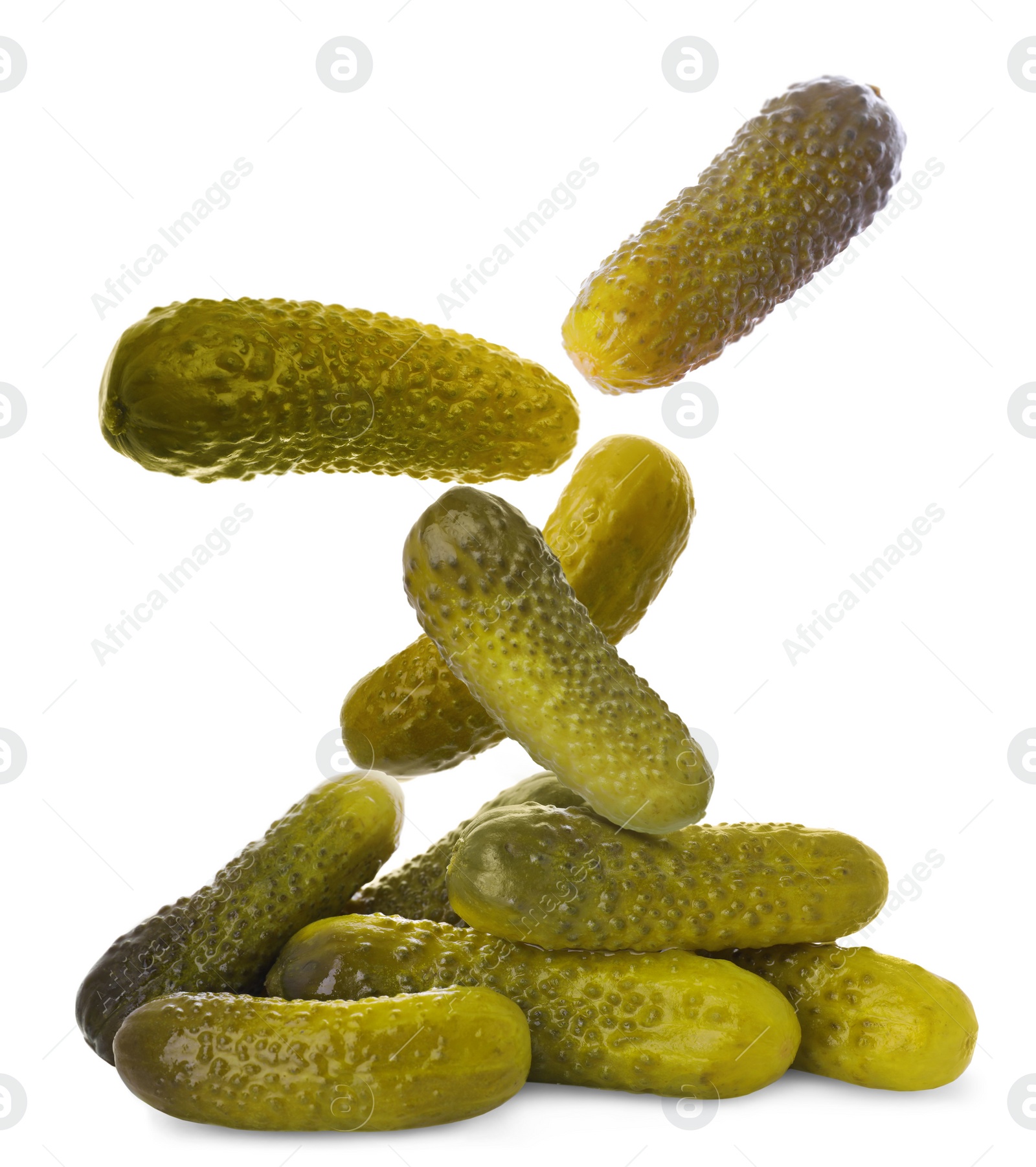 Image of Tasty pickled cucumbers falling into pile on white background