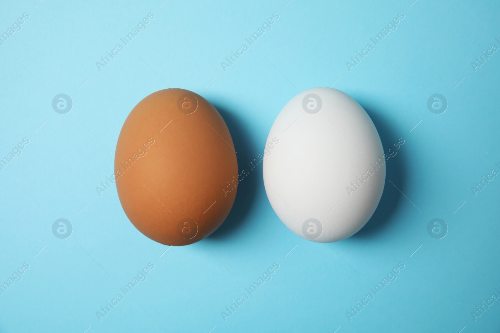 Photo of Raw chicken eggs on color background, top view