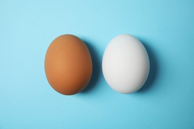 Photo of Raw chicken eggs on color background, top view