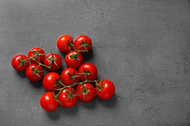 Photo of Fresh cherry tomatoes on stone background, flat lay. Space for text