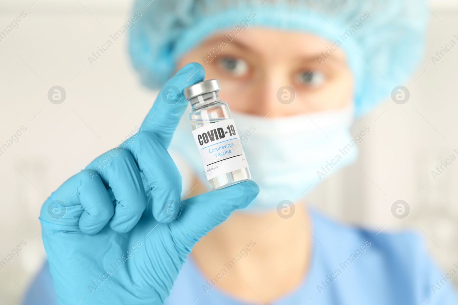 Photo of Doctor with coronavirus vaccine in laboratory, focus on hand