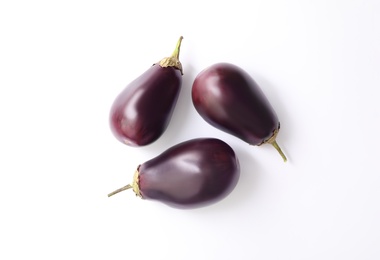 Photo of Raw ripe eggplants on white background, flat lay