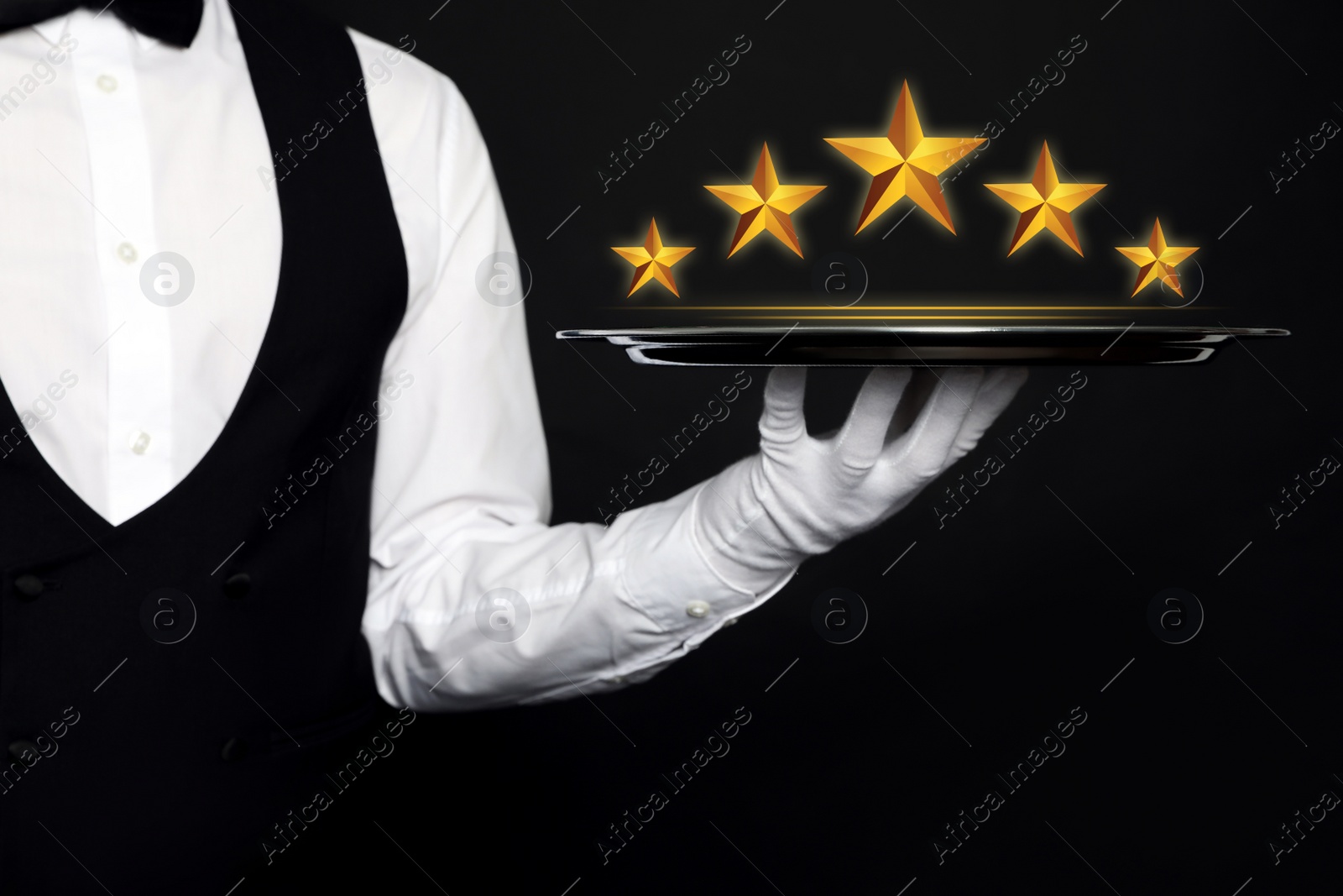 Image of Five Star Luxury Hotel. Waiter with tray on black background, closeup