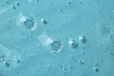 Photo of Cosmetic serum on light blue background, above view