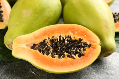 Fresh ripe papaya fruits on grey table, closeup