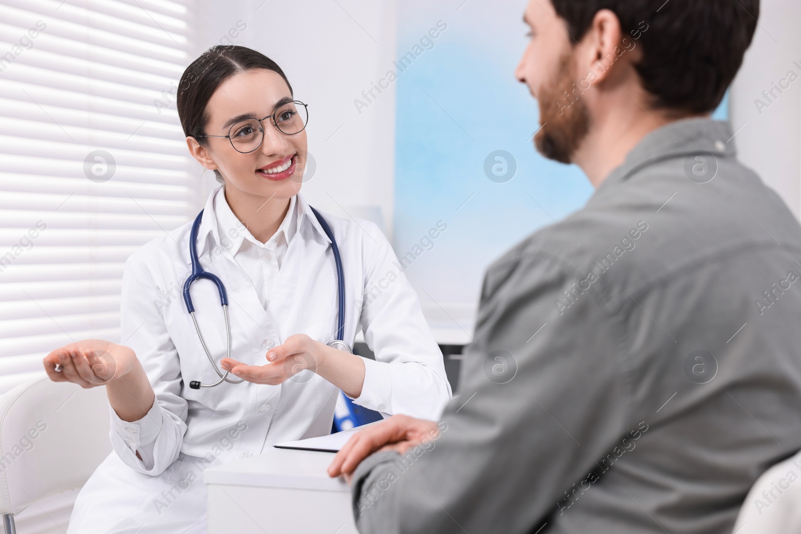 Photo of Doctor consulting patient during appointment in clinic