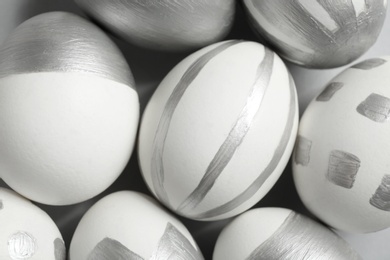 Photo of Painted Easter eggs on table, top view