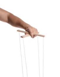 Man holding puppet control bar with strings on white background, closeup