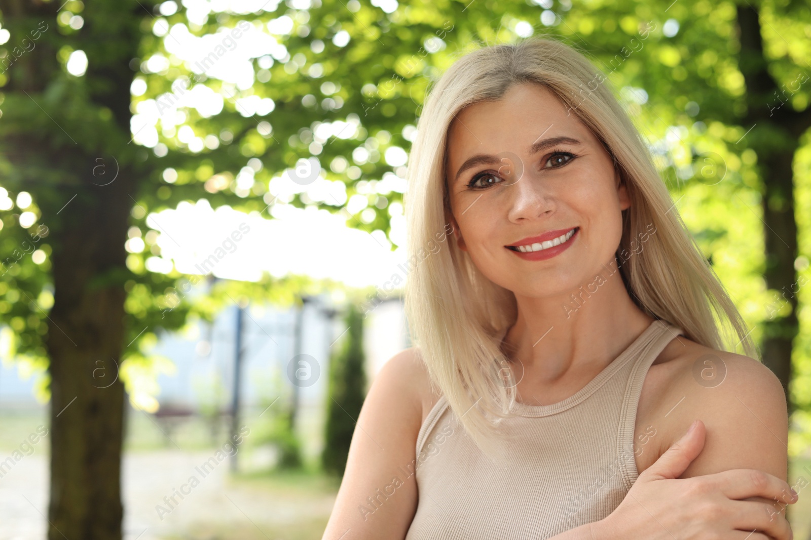 Photo of Portrait of beautiful woman outdoors on sunny day, space for text