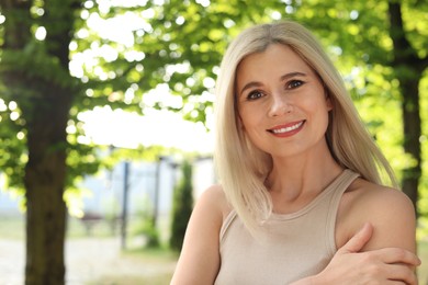 Portrait of beautiful woman outdoors on sunny day, space for text