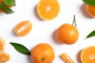 Photo of Composition with tangerines and leaves on white background, top view