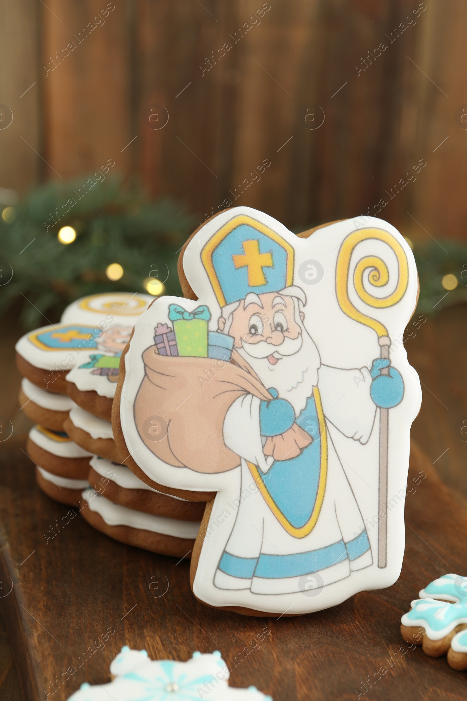 Photo of Tasty gingerbread cookie on wooden table. St. Nicholas Day celebration