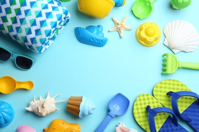 Photo of Flat lay composition with bright beach toys on color background. Space for text