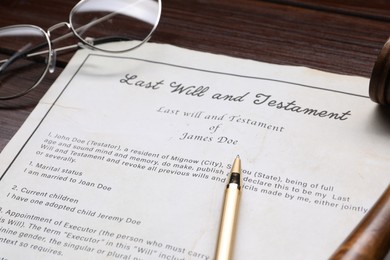 Photo of Last Will and Testament with glasses and pen on wooden table, closeup