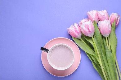 Cup of hot drink and beautiful tulips on light purple background, flat lay. Space for text