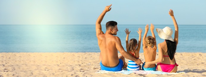 Image of Happy family on sandy beach near sea, space for text. Banner design