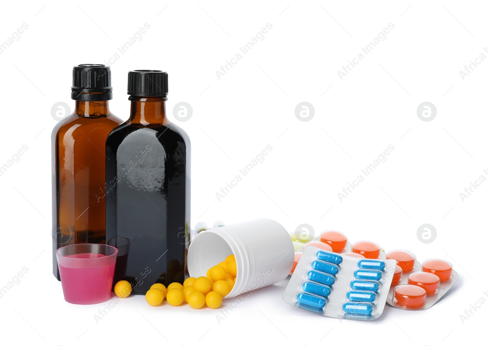 Photo of Cough syrup and different pills on white background