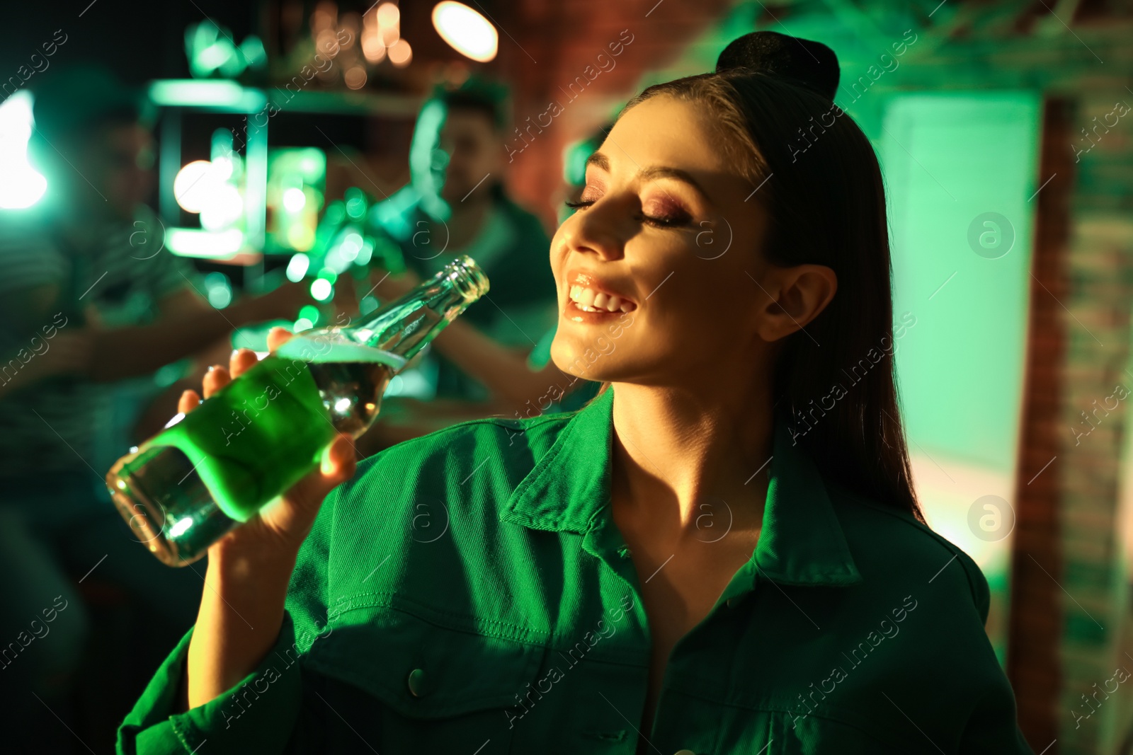 Photo of Woman with beer celebrating St Patrick's day in pub