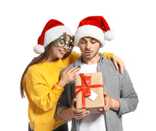 Photo of Young couple with Christmas gift on white background