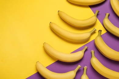 Ripe yellow bananas on color background, flat lay. Space for text