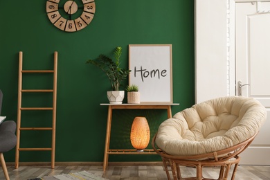 Stylish living room interior with green wall