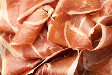 Photo of Slices of tasty cured ham as background, top view