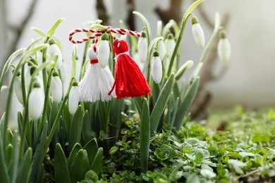 Traditional martisor and beautiful snowdrops outdoors. Symbol of first spring day