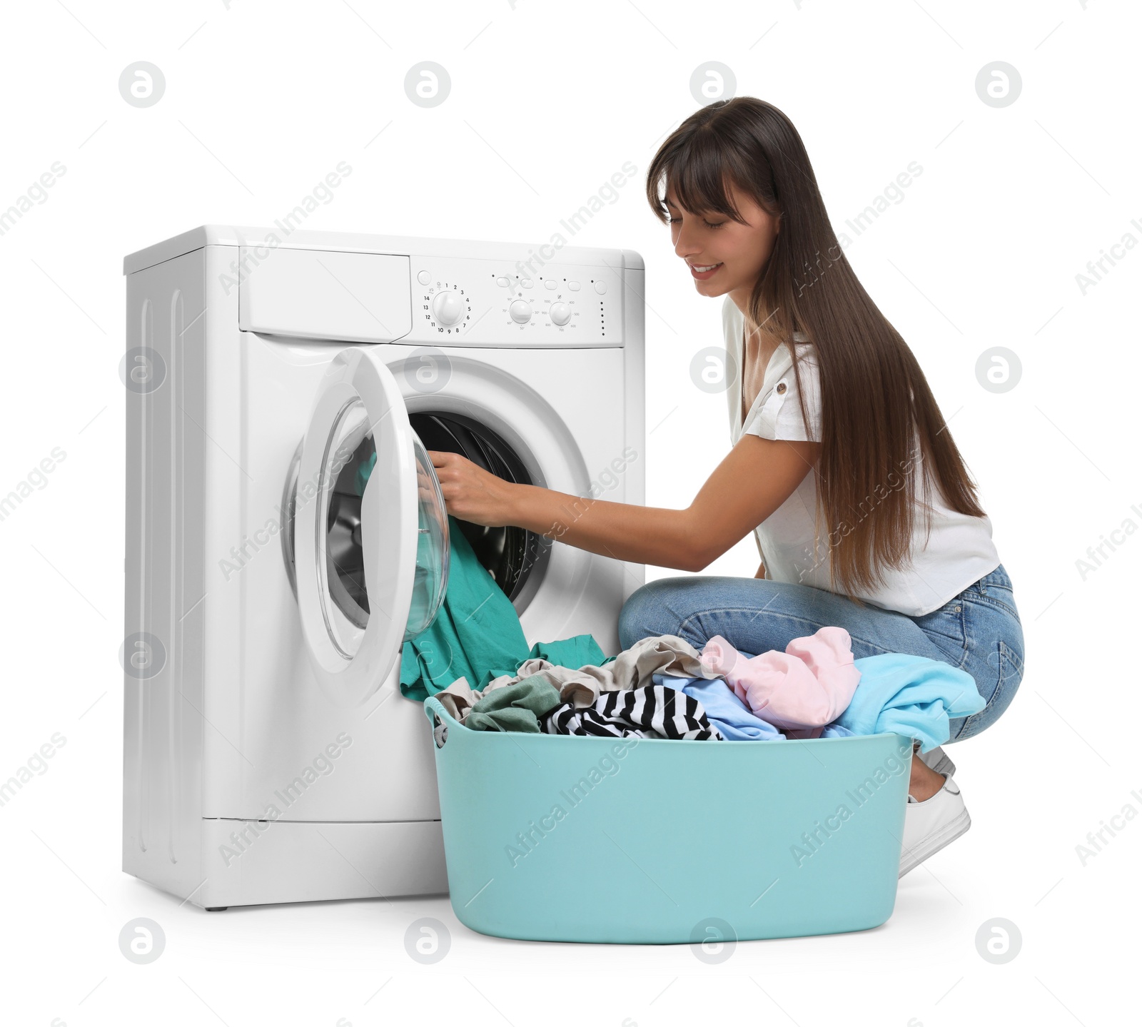 Photo of Beautiful woman taking laundry out of washing machine on white background