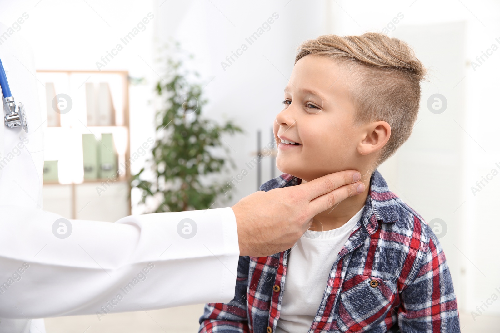 Photo of Doctor checking little boy's pulse with fingers in hospital