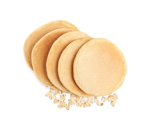 Photo of Tasty oatmeal pancakes and flakes on white background, top view