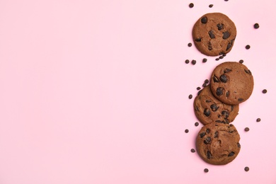 Photo of Delicious chocolate chip cookies on color background, flat lay. Space for text