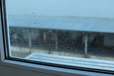 Photo of Window glass with water drops, closeup. Condensation