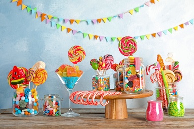 Photo of Composition with many different candies on table