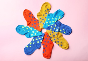 Photo of Cute child socks on color background, top view