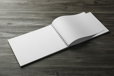 Blank paper brochure on wooden table. Mockup for design