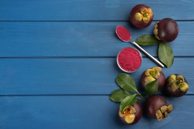 Purple mangosteen powder and fruits on blue wooden table, flat lay. Space for text