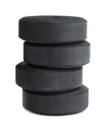 Photo of Stack of charcoal rings for hookah on white background