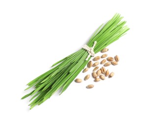 Photo of Sprouts of wheat grass and seeds isolated on white, top view