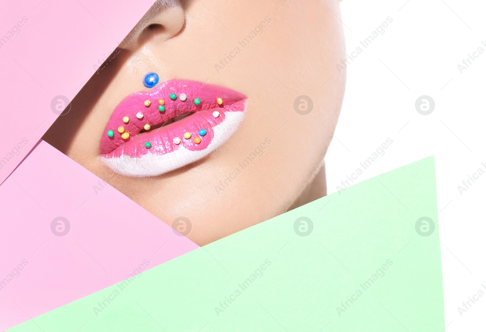 Photo of Beautiful young model with creative lips makeup and paper on white background