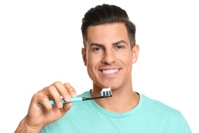 Man holding toothbrush with paste on white background