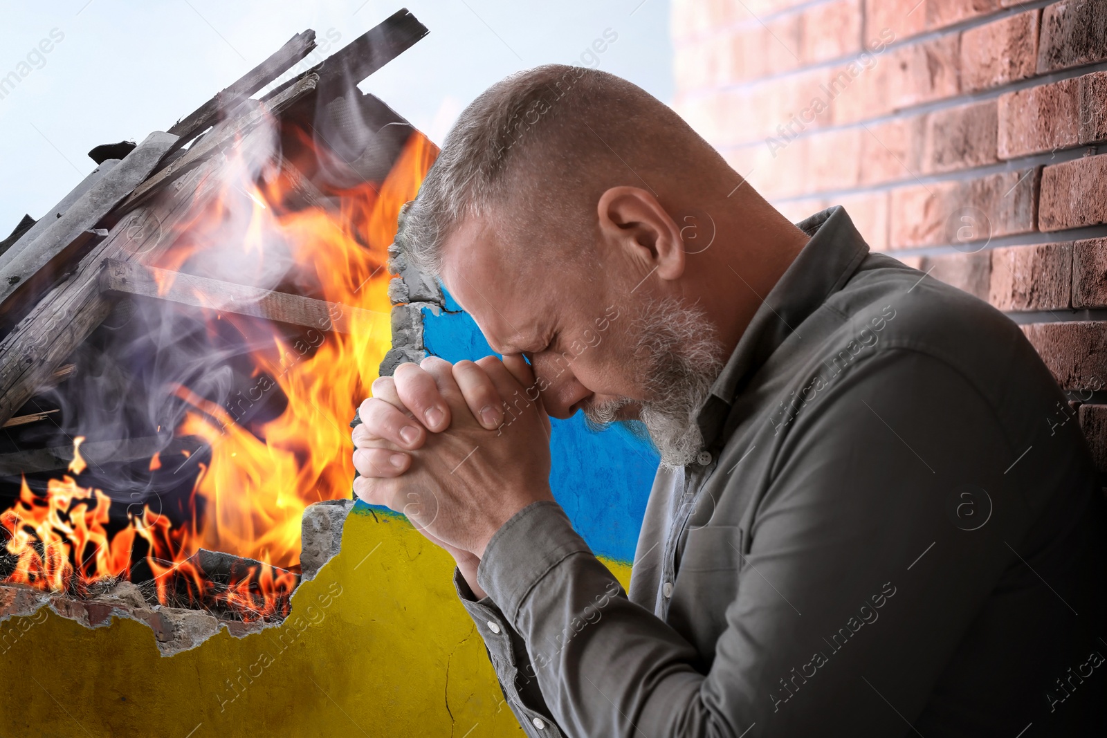 Image of Upset senior man near wall of ruined building painted in color of national flag on fire. Stop war in Ukraine