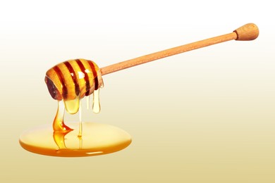 Image of Natural honey dripping from dipper on pale yellow background