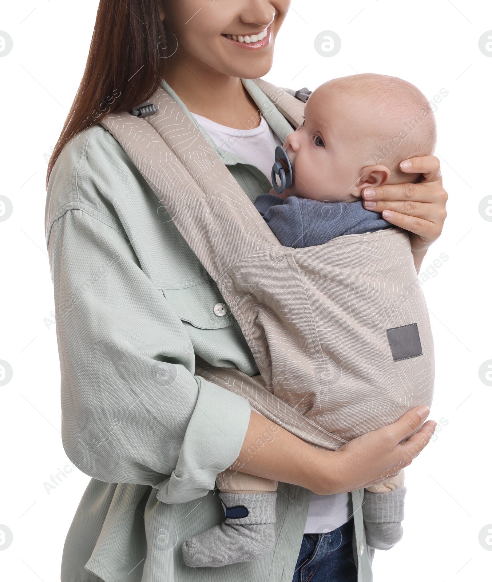 Photo of Mother holding her child in baby carrier on white background, closeup