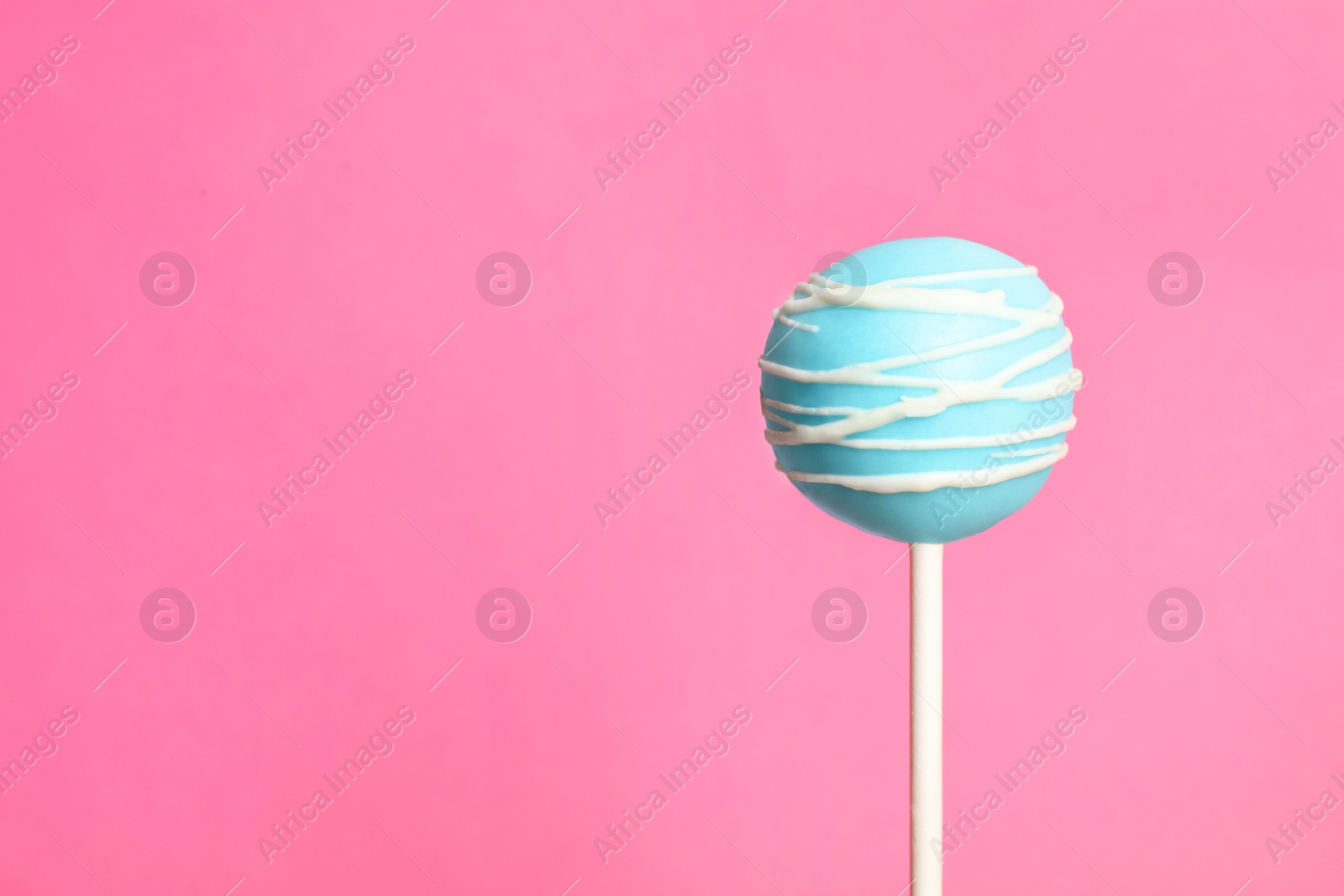 Photo of Bright delicious cake pop on color background. Space for text