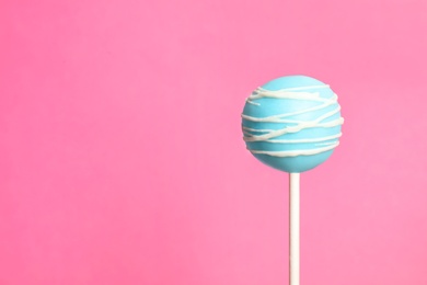 Bright delicious cake pop on color background. Space for text