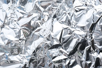 Crumpled silver foil as background, closeup view