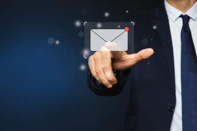 Image of Email. Man touching virtual screen with incoming letter notification against dark blue background, closeup