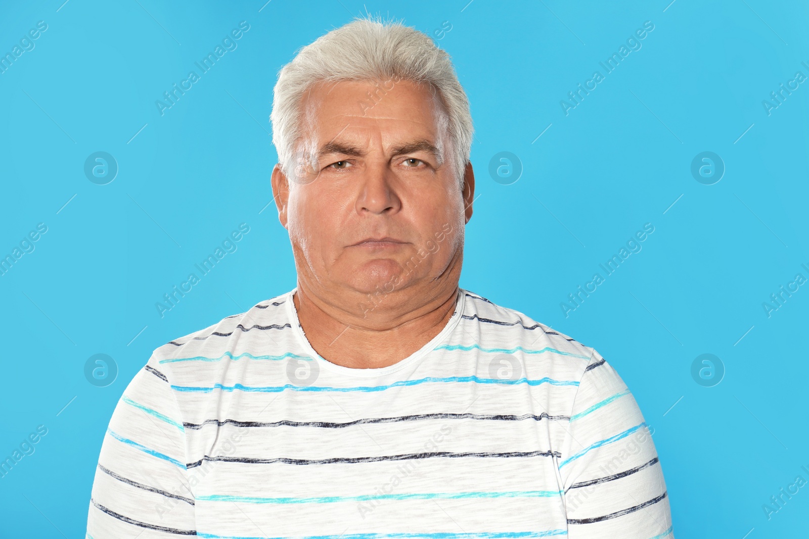 Photo of Mature man with double chin on blue background