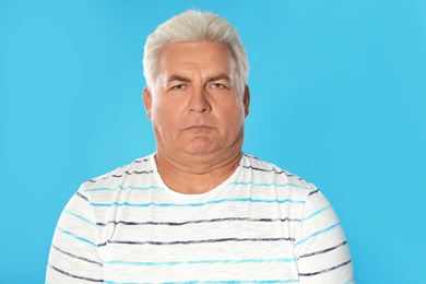 Photo of Mature man with double chin on blue background