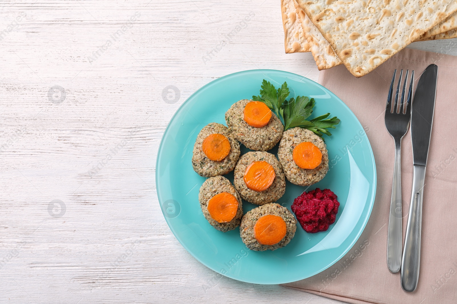 Photo of Flat lay composition with plate of traditional Passover (Pesach) gefilte fish on wooden background. Space for text